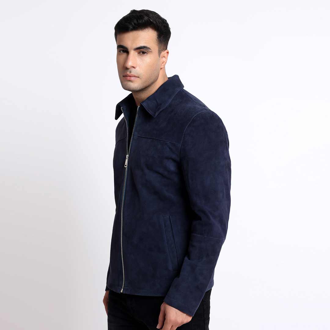 Side view of a man wearing a navy suede jacket with a shirt collar.