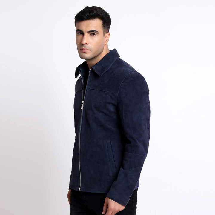Side view of a man wearing a navy suede jacket with a shirt collar.