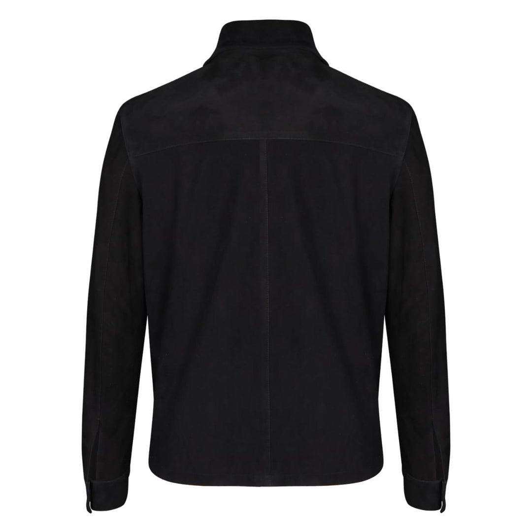 Full-length shot of a man wearing a black bomber jacket with fur trim.