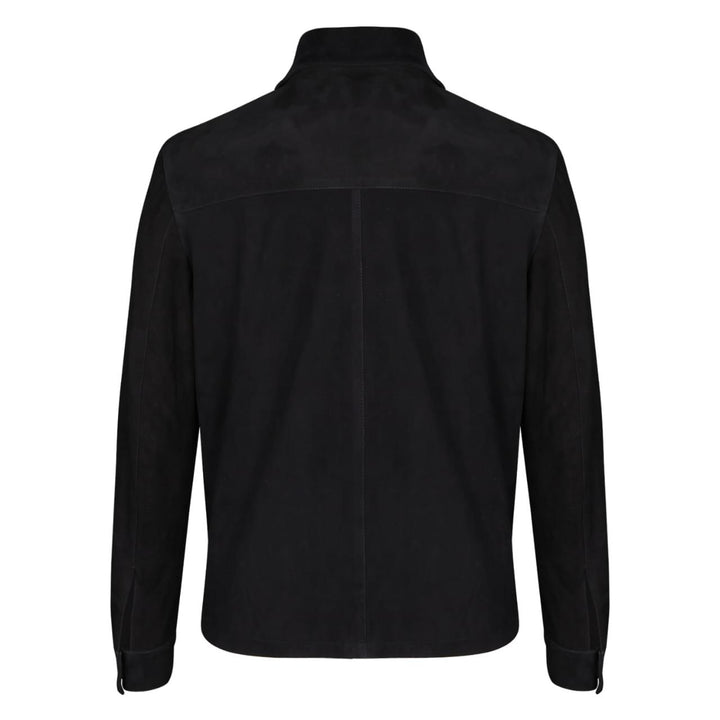Full-length shot of a man wearing a black bomber jacket with fur trim.