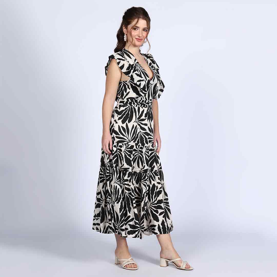 Close-up of V-neck bodice and ruffle trim on Saint black ivory palm-print lurex maxi dress for women UK.