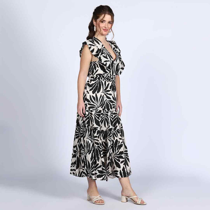 Close-up of V-neck bodice and ruffle trim on Saint black ivory palm-print lurex maxi dress for women UK.