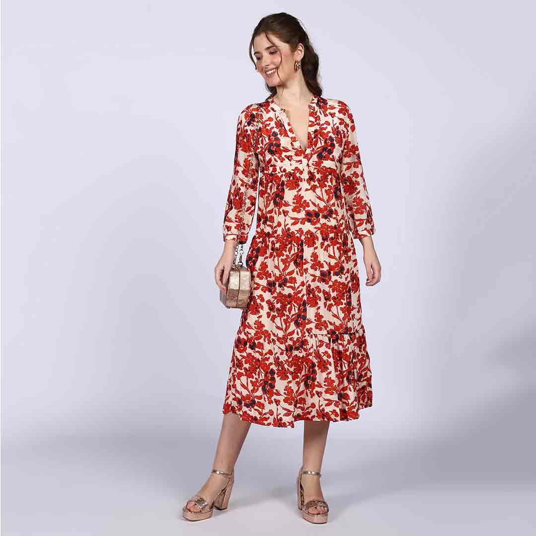 Women's ivory red floral midi dress by Saint Brunella, front view styled with a shoulder bag.