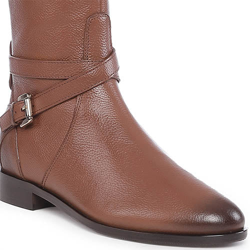 Close-up of buckle strap detail on Saint Cara tan leather knee high boots