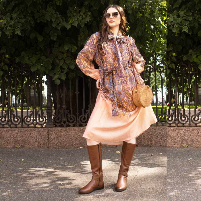 Women's tan leather knee high boots by Saint Cara, styled outdoor lifestyle shot