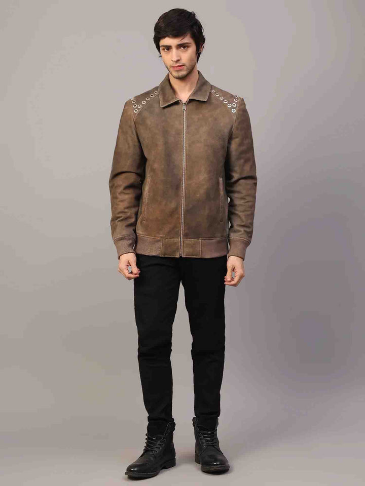 Side view of a man wearing a distressed brown suede jacket with grommet hardware.
