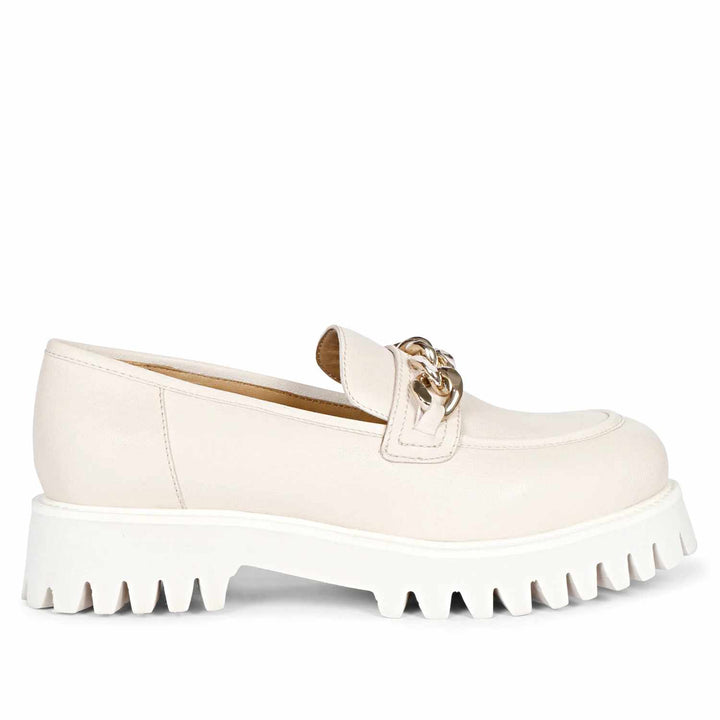 A pair of offwhite leather moccasins with metal chain embellishment at the vamp, featuring a slip-on style and white eva sole.