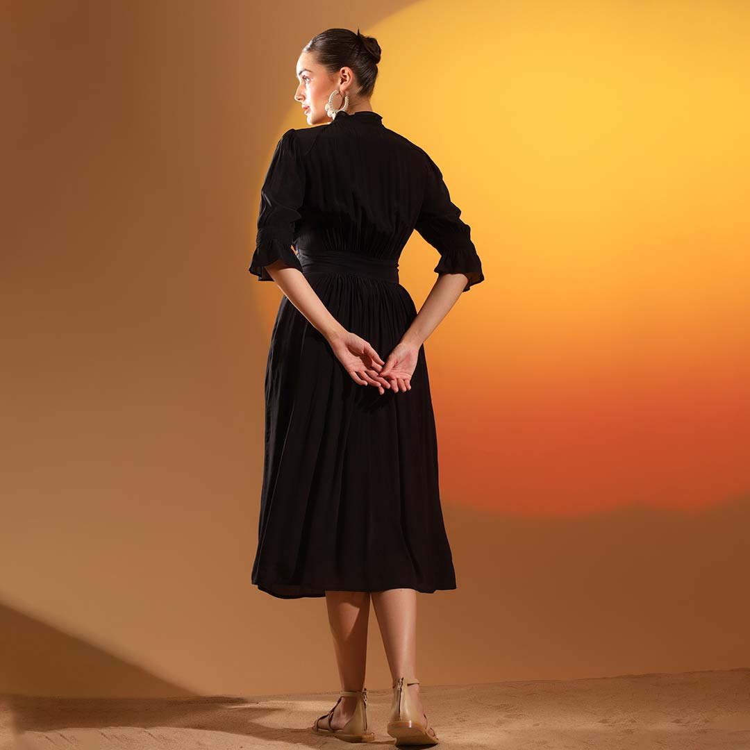Women's coal black solid viscose midi dress by Saint, back view.