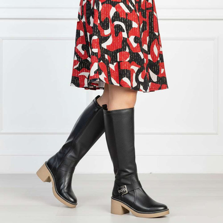 Women's Saint Dahlia black leather long boots styled with a printed skirt, lifestyle view