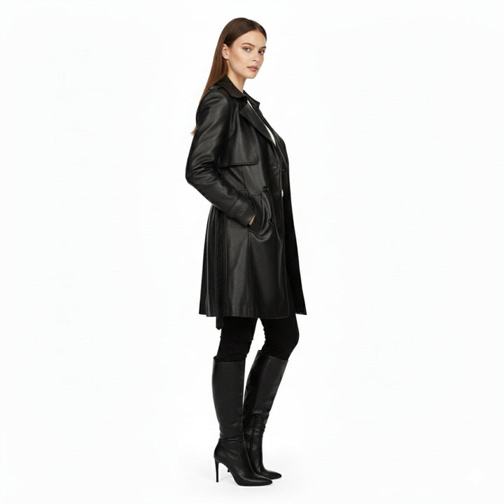 Women's black leather trench coat UK by Saint Davina, side view showing belted waist