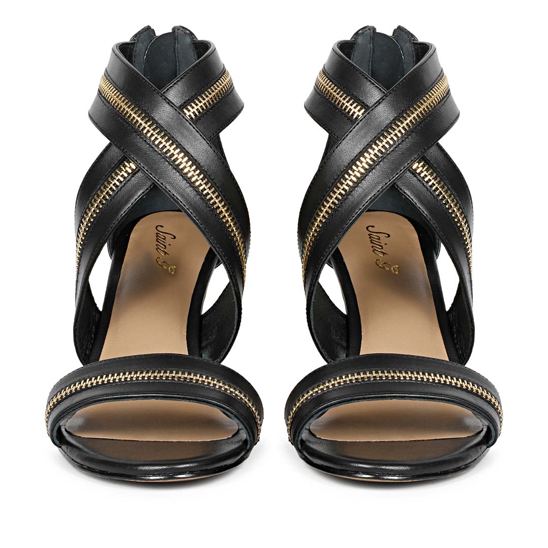 Saint Delilah black leather stiletto heels featuring criss-cross gold zip straps front view