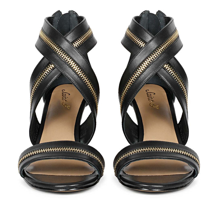 Saint Delilah black leather stiletto heels featuring criss-cross gold zip straps front view