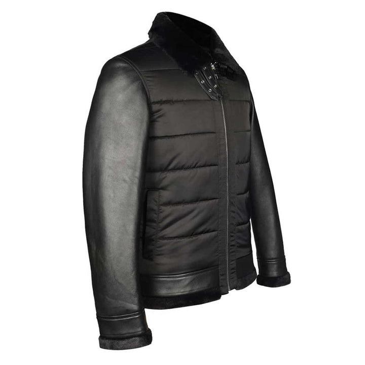 Side view of a man wearing a black quilted jacket with a fur collar.