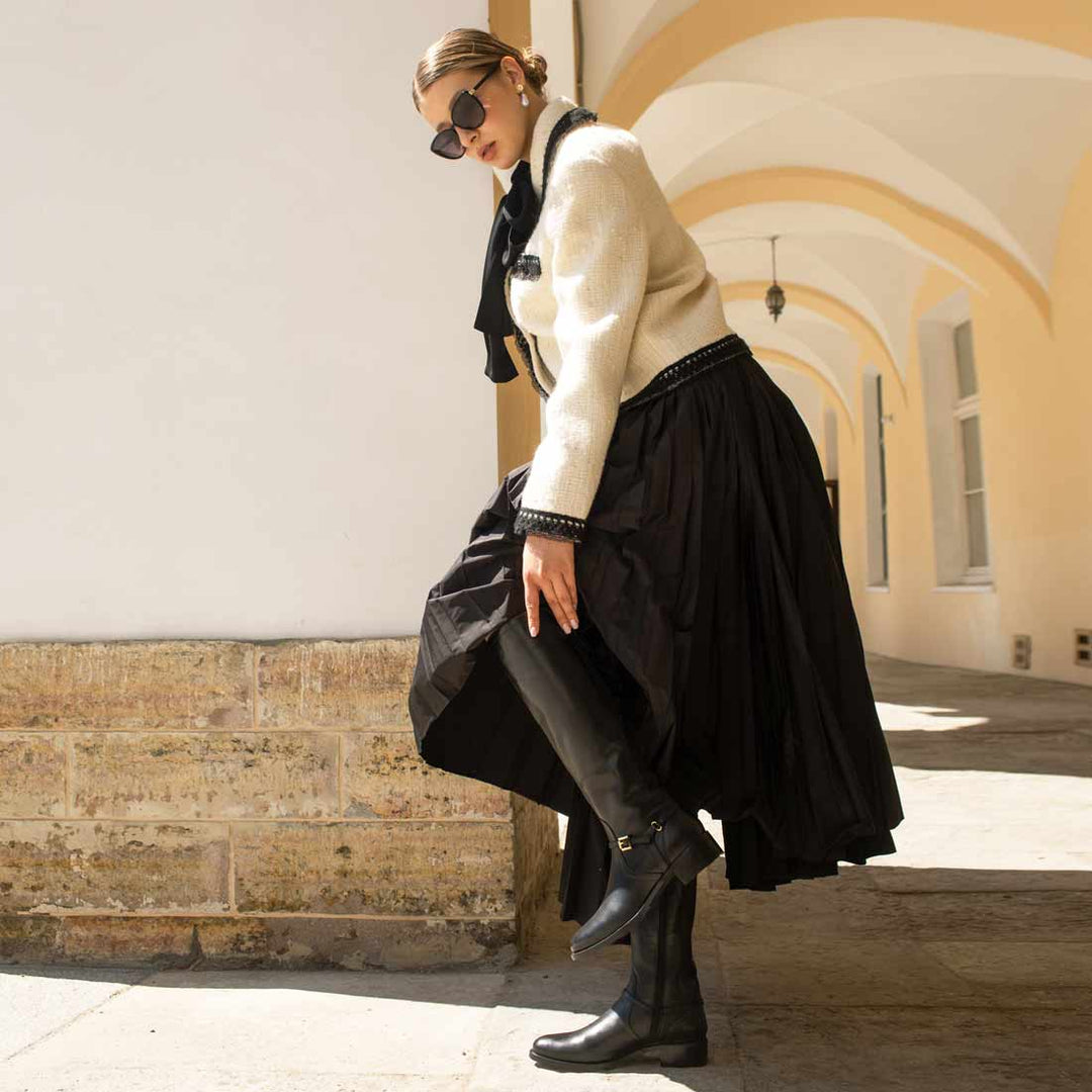 Women's black leather knee high boots by Saint Drusilla, styled editorial lifestyle shot