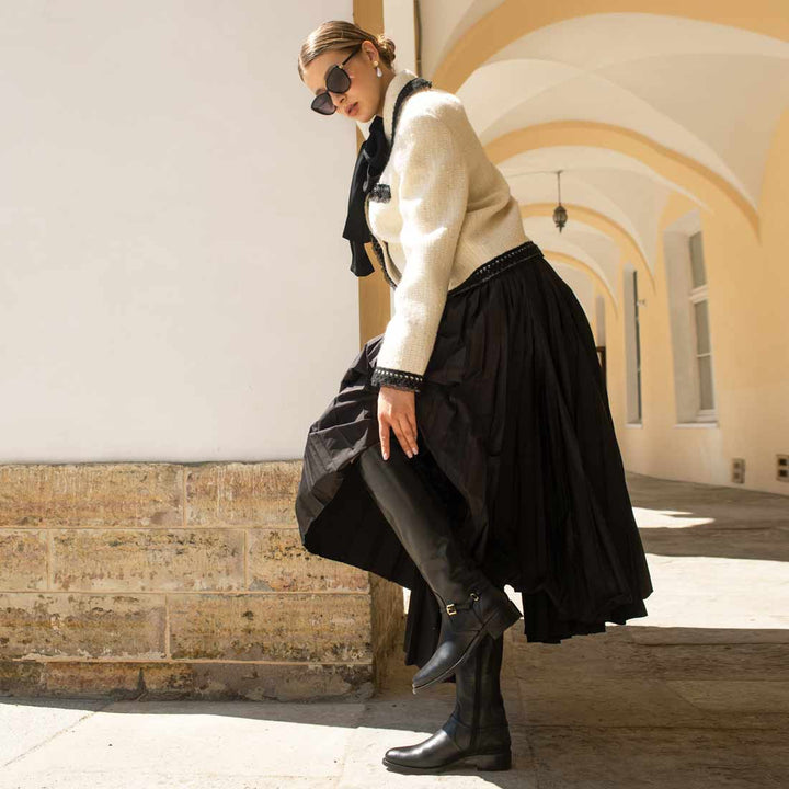 Women's black leather knee high boots by Saint Drusilla, styled editorial lifestyle shot