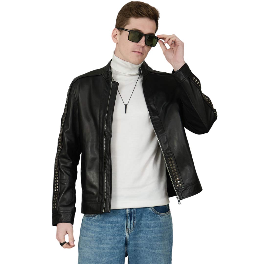 Man wearing an open black leather jacket with studded sleeve trim, front view.