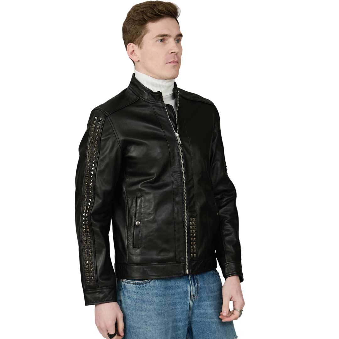 Side view of a man wearing a black leather jacket with studded sleeve trim.
