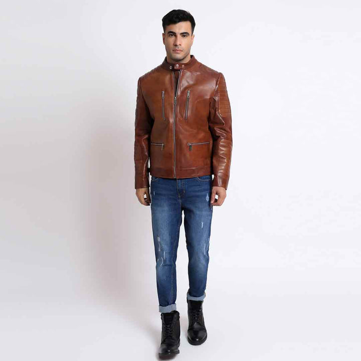 Full-length shot of a man wearing a tan/cognac brown leather cafe racer jacket.