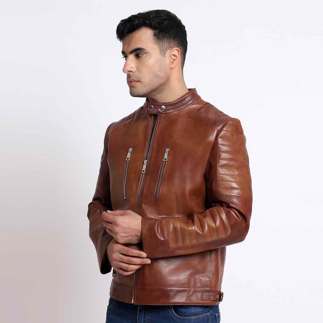 Man wearing a zipped-up tan/cognac brown leather cafe racer jacket.