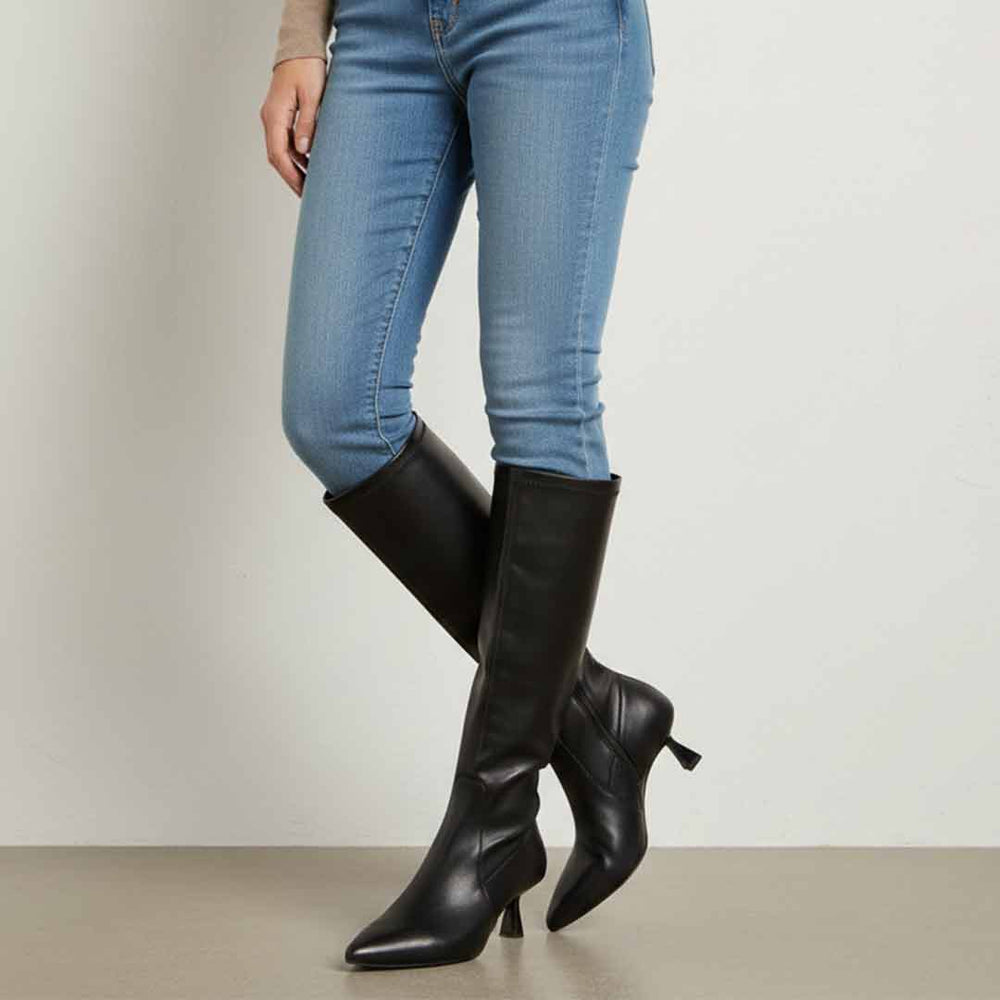 Women's Saint Emilia black knee high boots styled with skinny jeans, lifestyle view