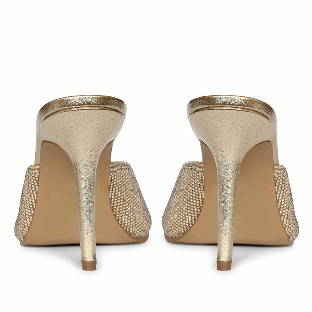 Saint Estrella glow crystal stiletto heels with iridescent crystal embellishment and ankle strap, back view