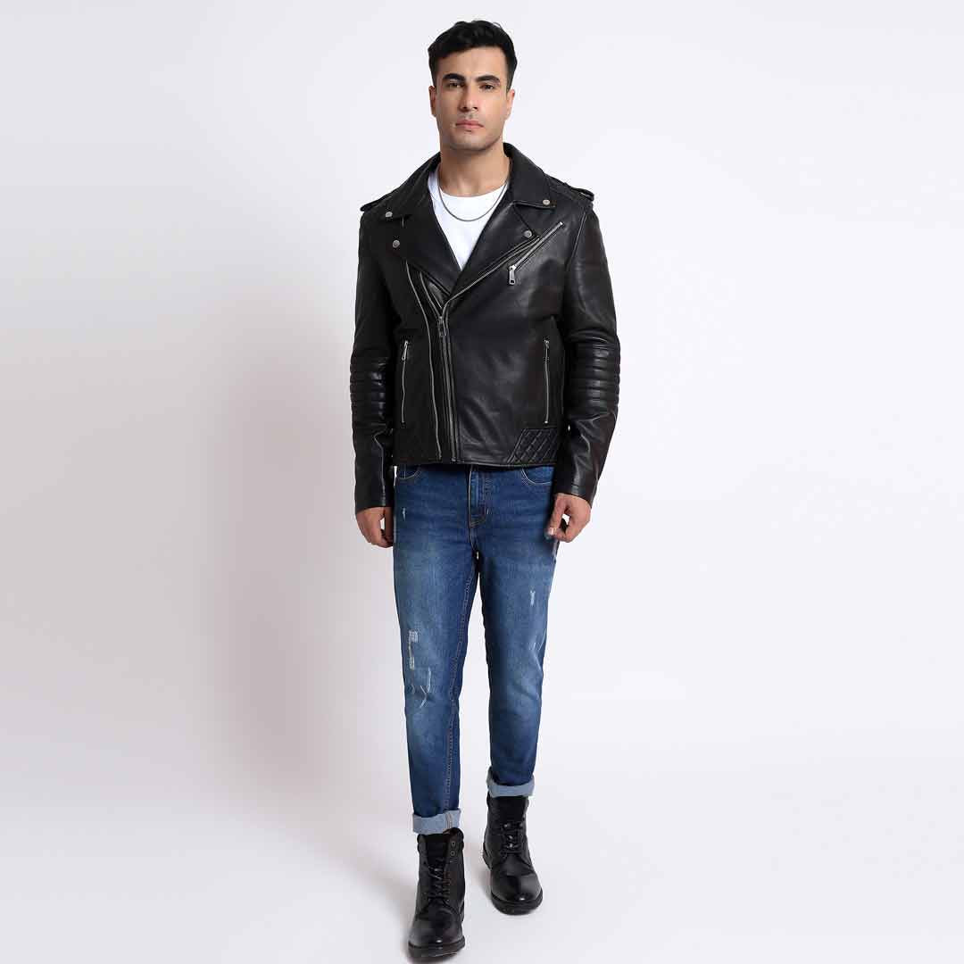 Full-length view of a man wearing a black leather biker jacket with jeans and boots.
