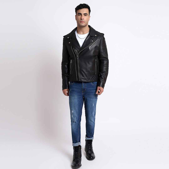 Full-length view of a man wearing a black leather biker jacket with jeans and boots.
