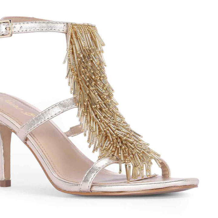 Close-up detail on Women's Saint Faye Gold Leather Fringe Stilettos