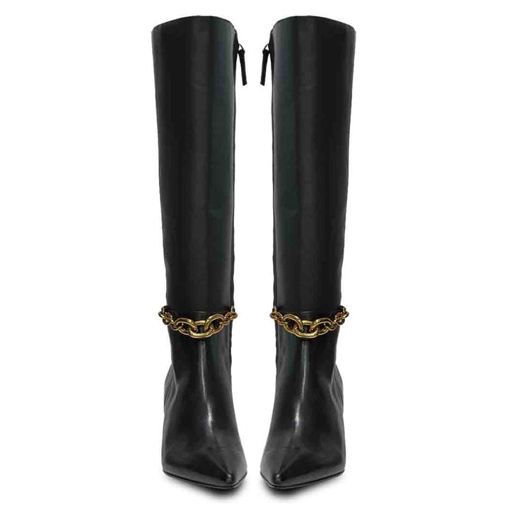 Women's black leather knee high boots, front pair view of gold chain embellishment