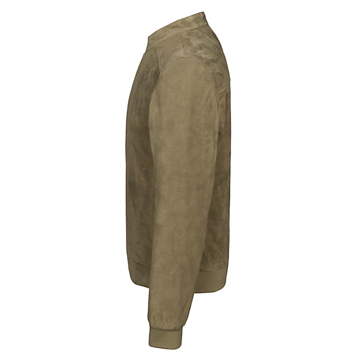 Side view of a man wearing a khaki/tan suede bomber-style jacket.