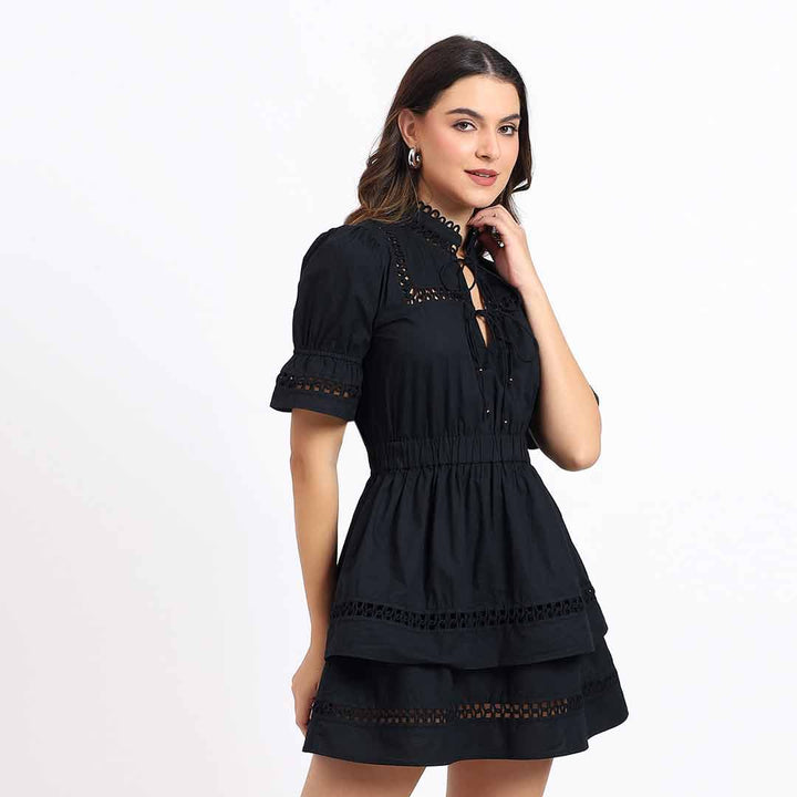 Women's black lace-trim tiered short dress by Saint Gianna, three-quarter front view.