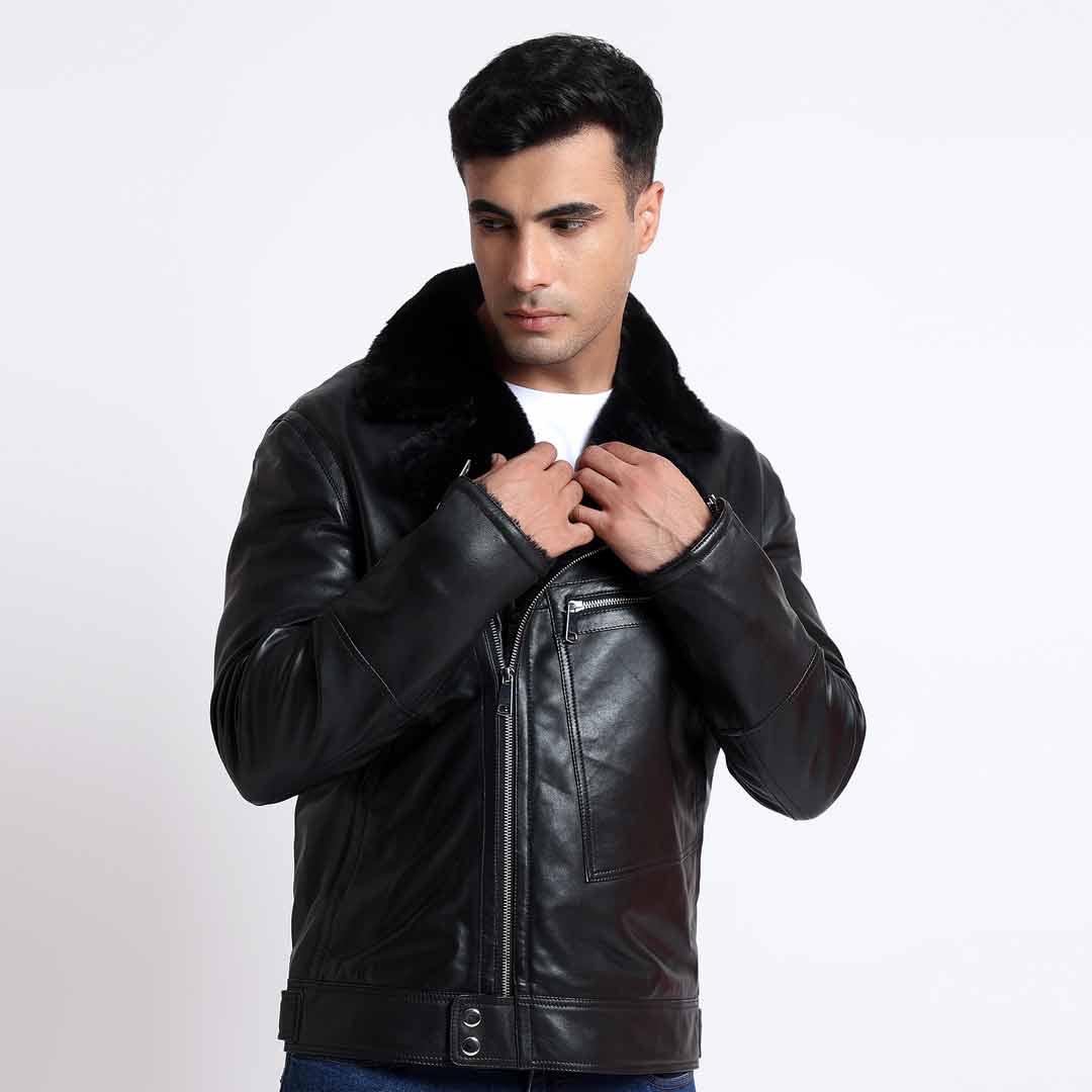 Man adjusting the fur-trimmed collar of a black leather biker jacket, close-up.