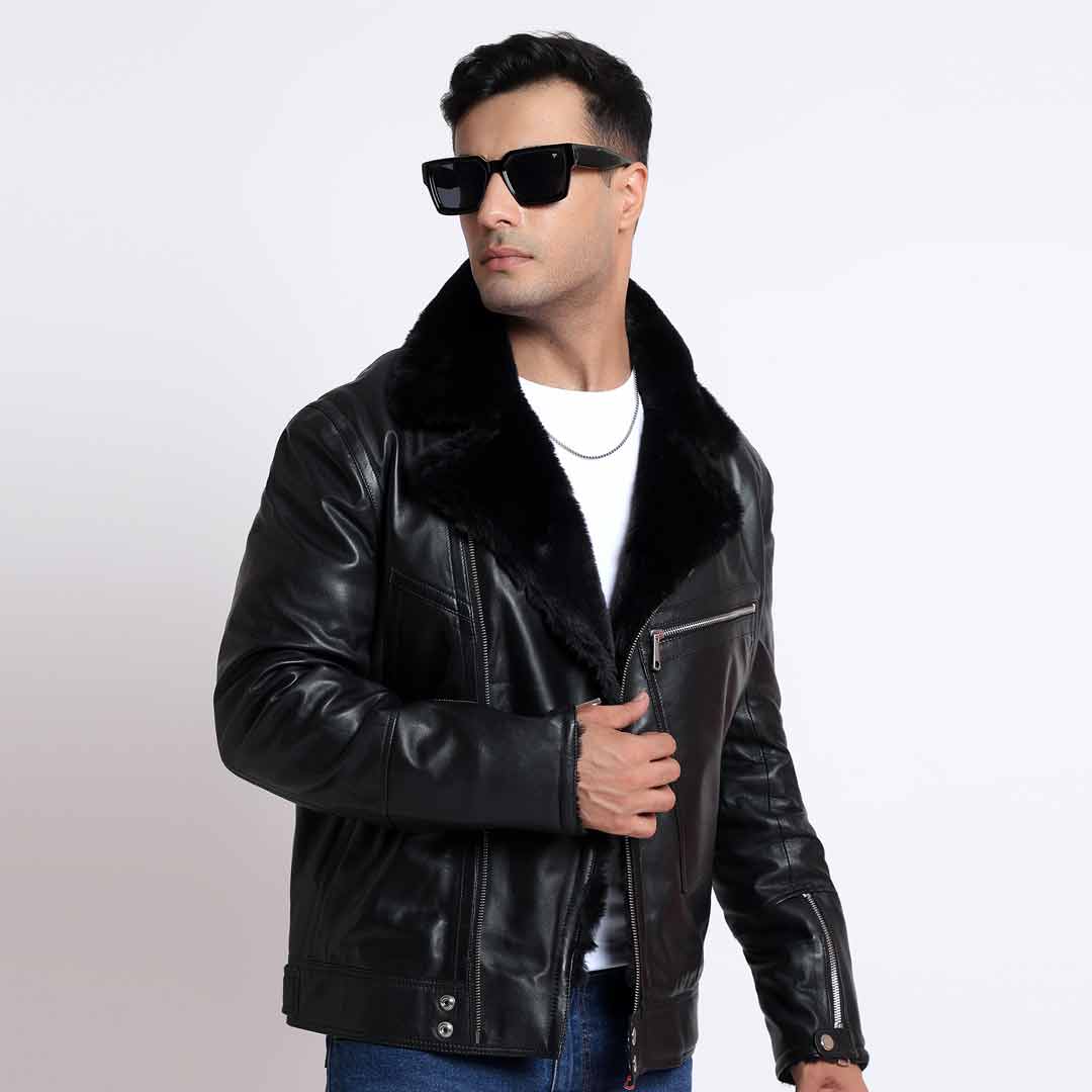 Man wearing a black leather biker jacket with a fur collar, styled with jeans.