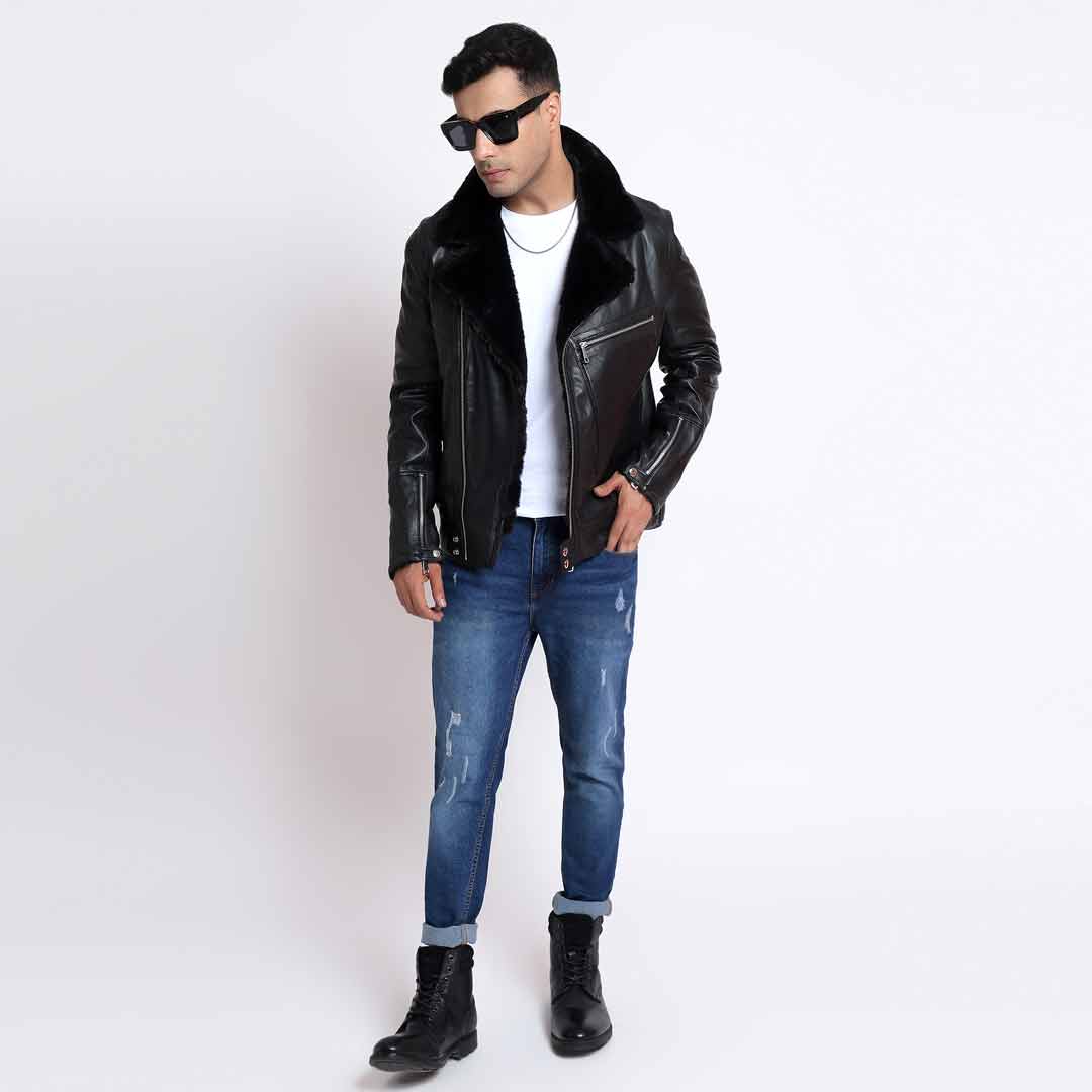 Full-length view of a man wearing a black leather biker jacket, jeans and boots.