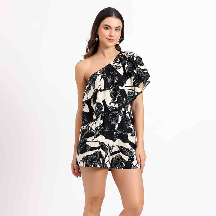 Women's black floral one-shoulder playsuit by Saint Hazel, full front view showing tailored shorts.