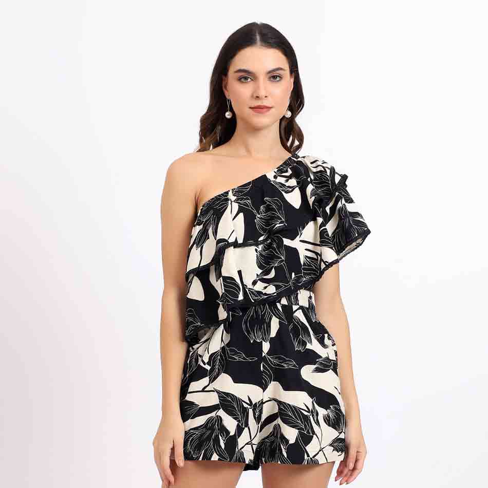 Saint Hazel black floral one-shoulder playsuit for women UK, front view with ruffle shoulder detail.