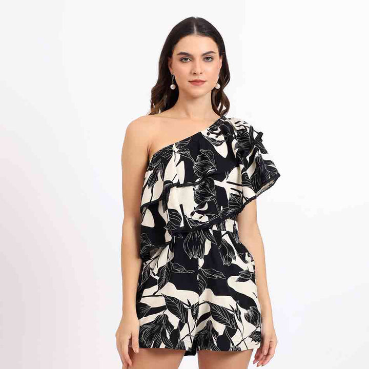 Saint Hazel black floral one-shoulder playsuit for women UK, front view with ruffle shoulder detail.