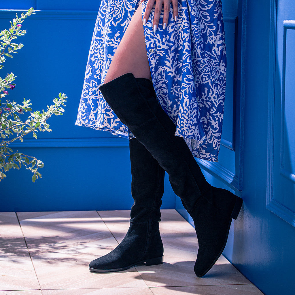 Women's black suede above the knee boots UK by Saint Isabella, styled walking lifestyle shot