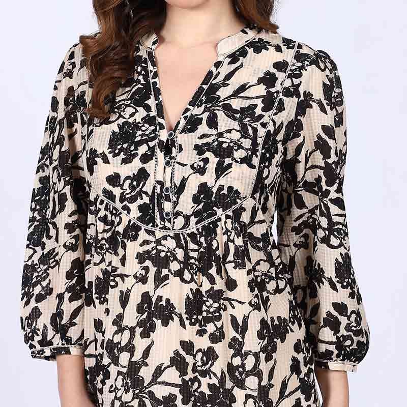 Close-up of V-neck placket on Saint ivory black floral viscose midi dress for women UK.
