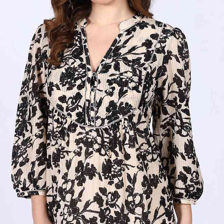 Close-up of V-neck placket on Saint ivory black floral viscose midi dress for women UK.