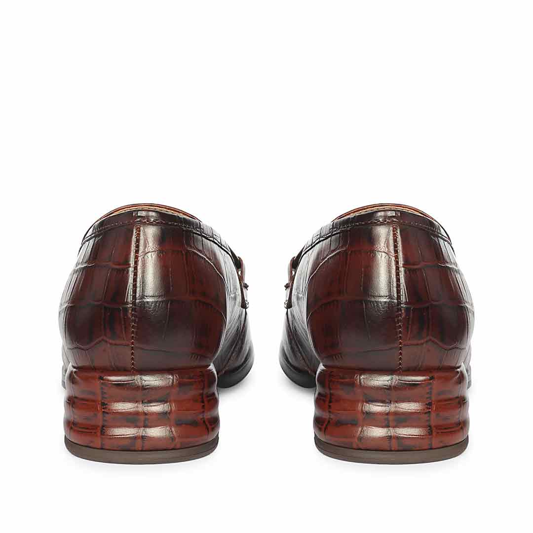 Ladies best croc-embossed chocolate leather moccasin detail, saddle and stitching close-up, UK