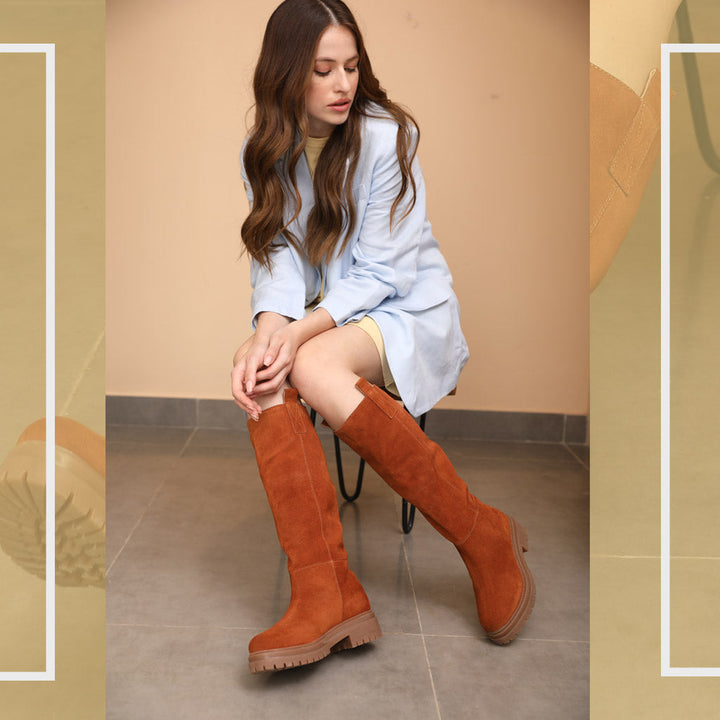Women's suede knee high boots by Saint Janet, styled seated lifestyle shot