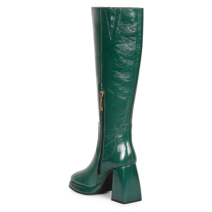 Saint Jolene green patent knee high boots, angled back view of platform heel