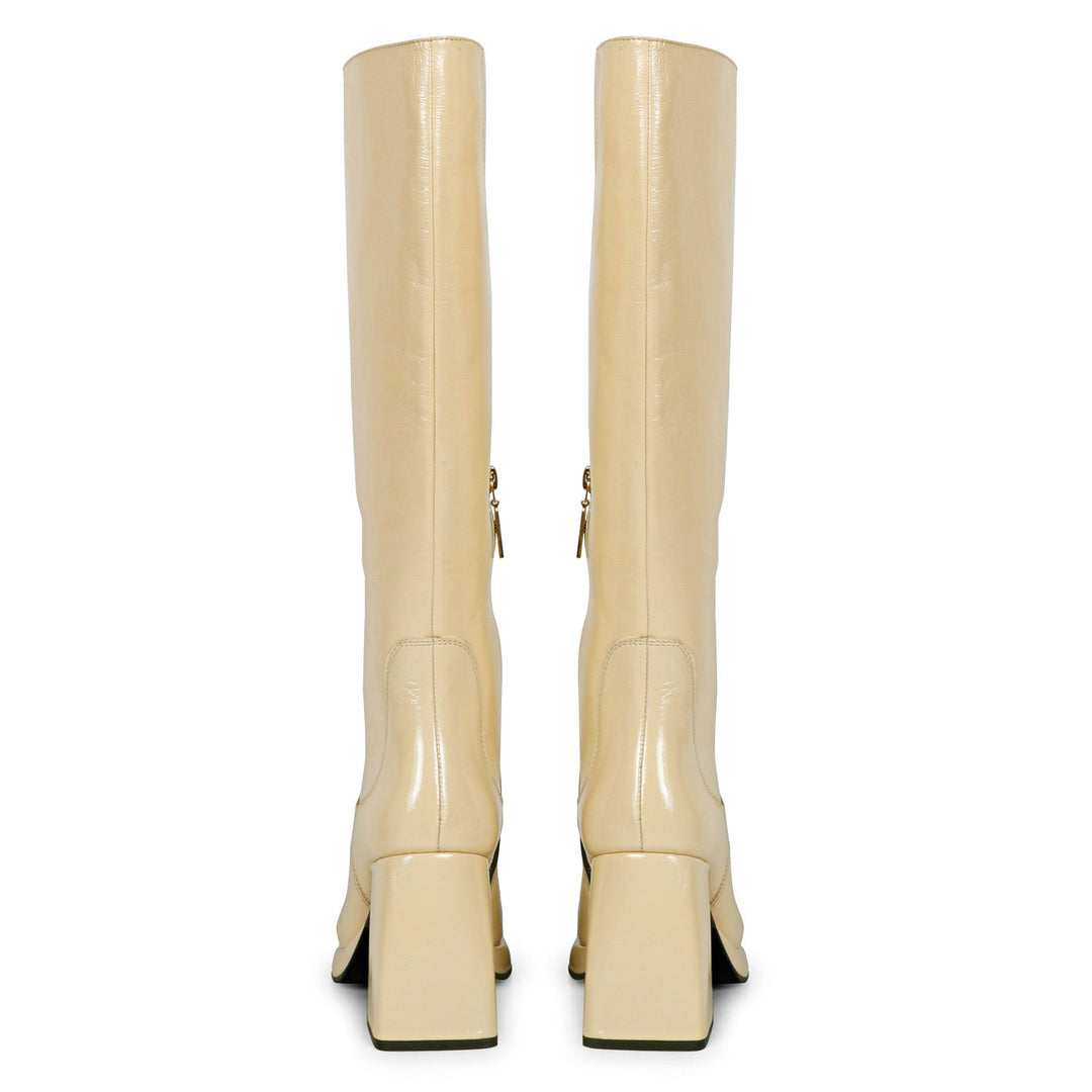 Saint Jolene off white patent leather boots, back pair view showing flared heel