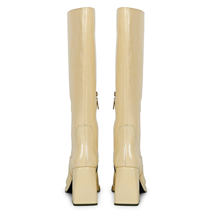Saint Jolene off white patent leather boots, back pair view showing flared heel