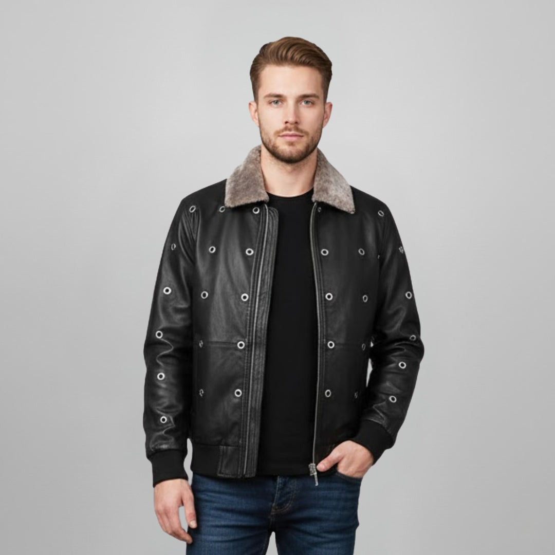Man wearing a black leather bomber jacket with grommet hardware and a shearling collar.