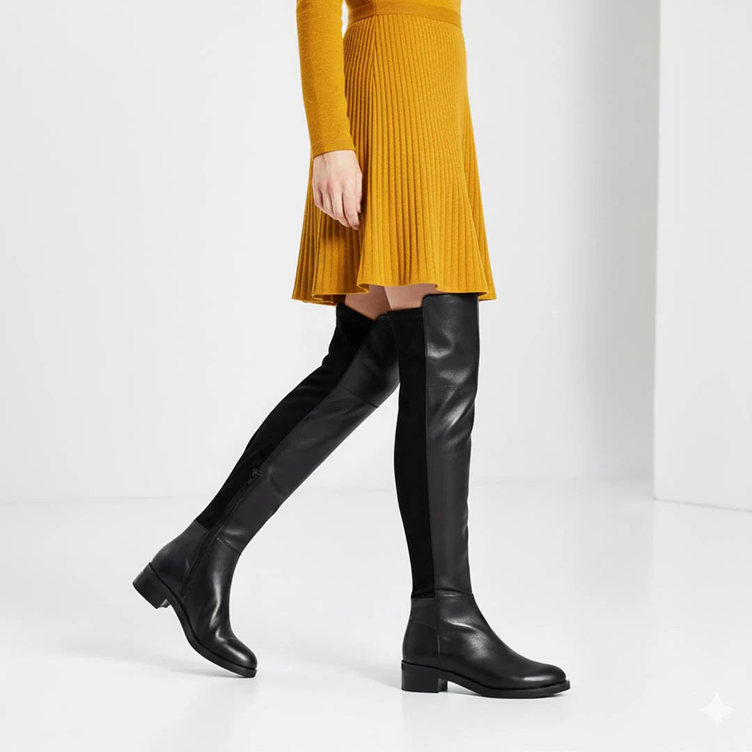 Women's black leather above the knee boots UK by Saint Kayleigh, styled walking lifestyle shot