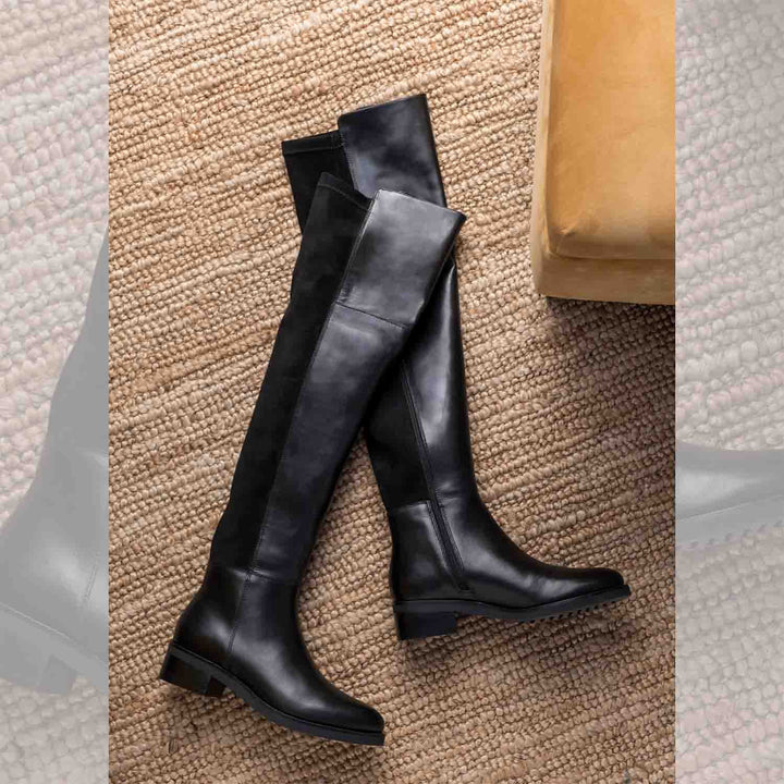 Women's black leather above the knee boots UK by Saint Kayleigh, styled flat-lay lifestyle shot