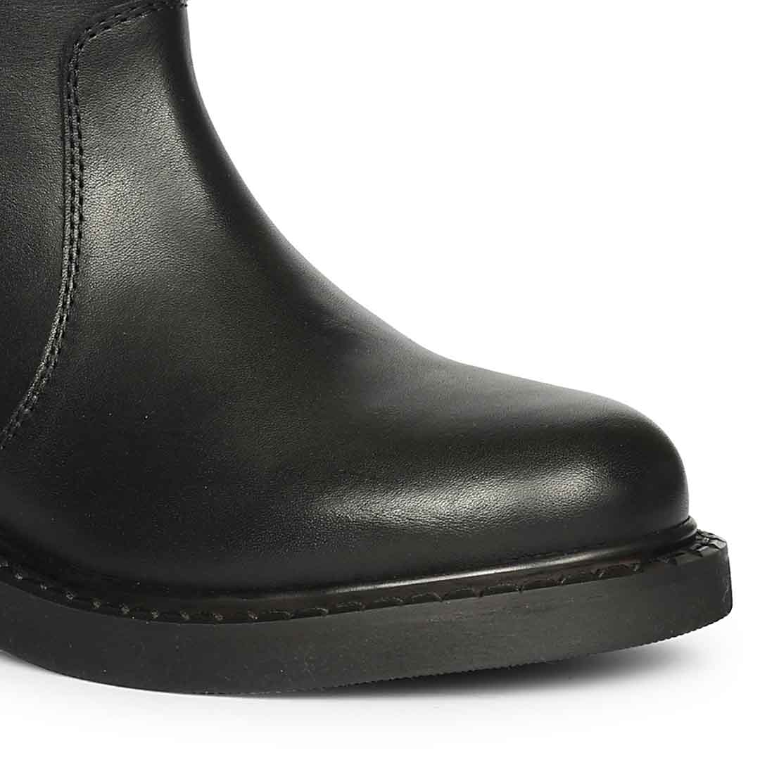 Close-up of round toe and block heel on Saint Lilah black leather long boots