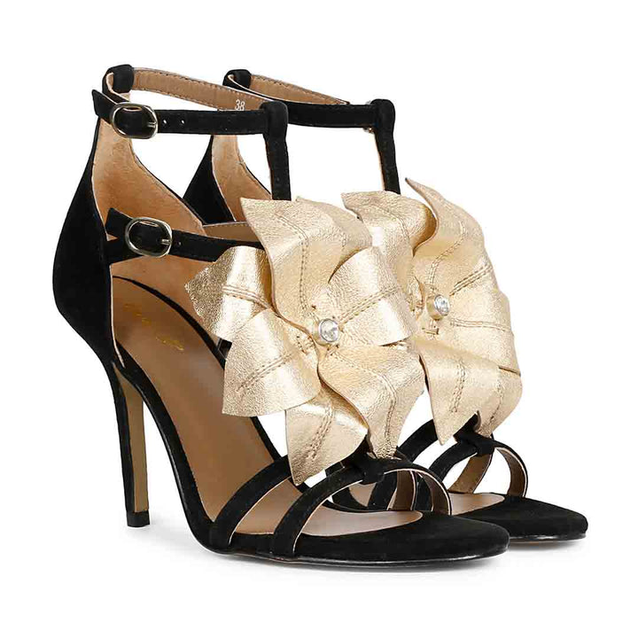 Saint Lilly gold flower embellished black leather stilettos with ankle strap detail, pair view